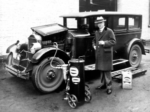 Adding motor oil (L. D. Taylor) to automobile (ca193-) - Vancouver BC